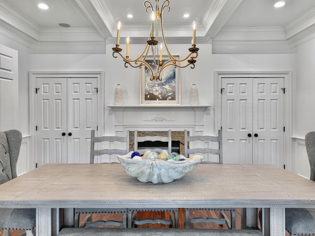 dining room with beamed ceiling, crown molding, and a chandelier