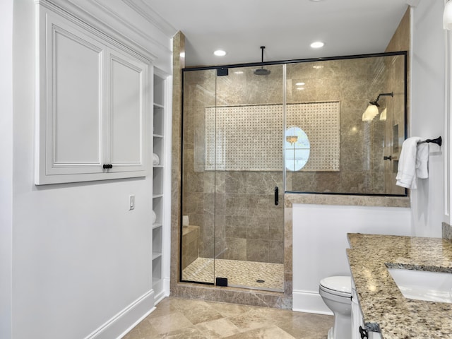 bathroom with vanity, toilet, and a shower with door