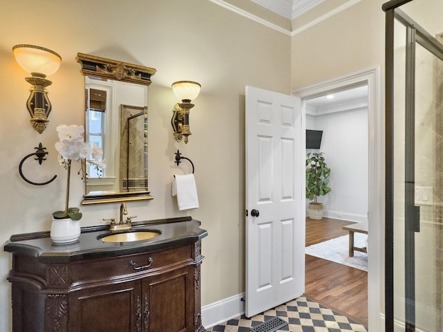 bathroom featuring vanity, wood-type flooring, ornamental molding, and walk in shower