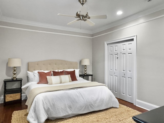 bedroom featuring dark hardwood / wood-style flooring, ceiling fan, a closet, and crown molding