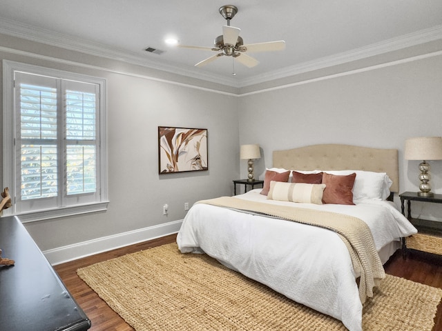 bedroom featuring multiple windows, dark hardwood / wood-style floors, ceiling fan, and ornamental molding