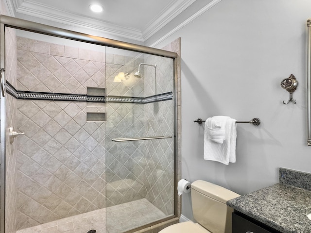 bathroom featuring vanity, ornamental molding, an enclosed shower, and toilet