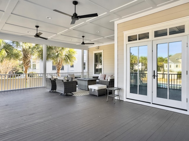 wooden terrace with outdoor lounge area and french doors