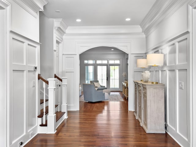 foyer with french doors, dark hardwood / wood-style floors, and ornamental molding