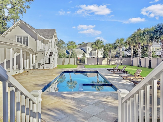 view of swimming pool with a yard and a patio