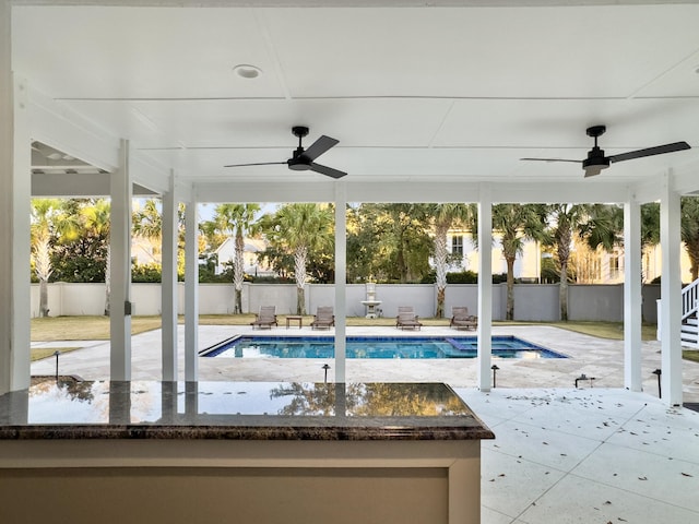 view of pool with a patio and ceiling fan