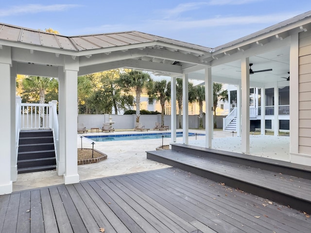 view of pool featuring ceiling fan and a wooden deck