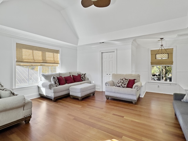 living room with ceiling fan, hardwood / wood-style floors, and vaulted ceiling