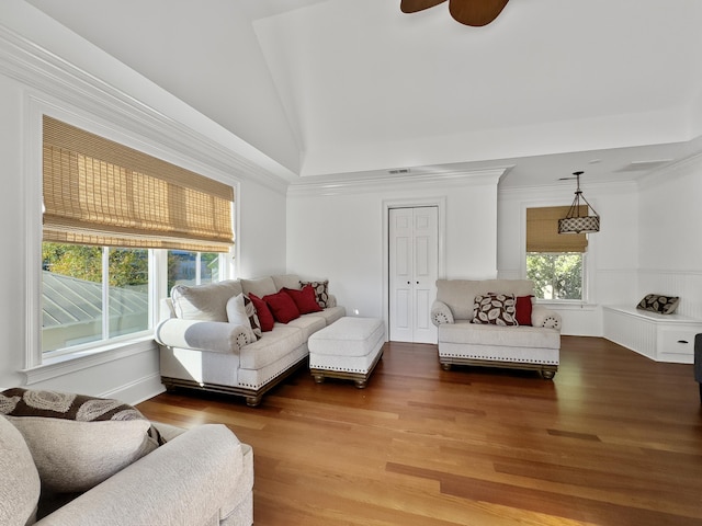 living room featuring hardwood / wood-style floors, vaulted ceiling, ceiling fan, and ornamental molding