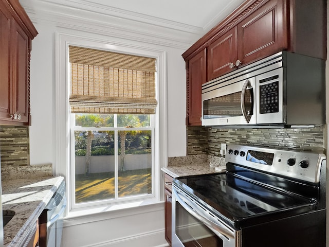 kitchen featuring decorative backsplash, light stone counters, stainless steel appliances, and crown molding