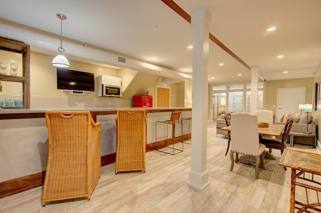 dining space with light wood-type flooring