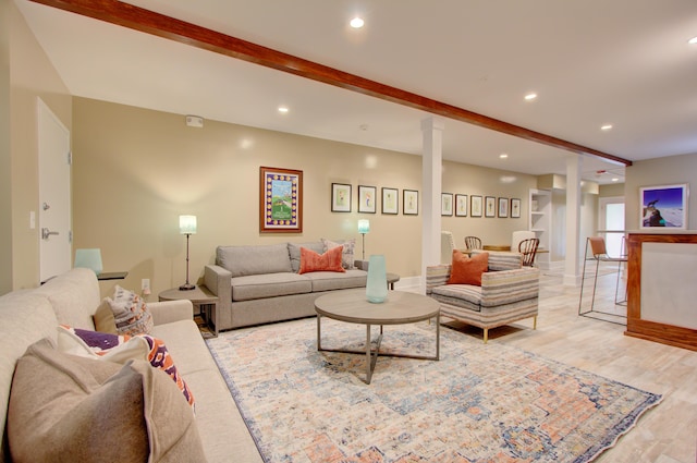 living room with beamed ceiling and light wood-type flooring