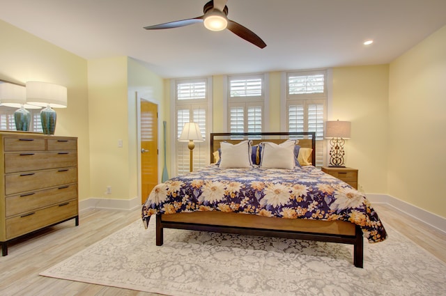 bedroom featuring light hardwood / wood-style flooring and ceiling fan