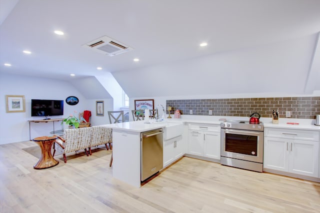 kitchen featuring white cabinetry, stainless steel appliances, tasteful backsplash, kitchen peninsula, and lofted ceiling