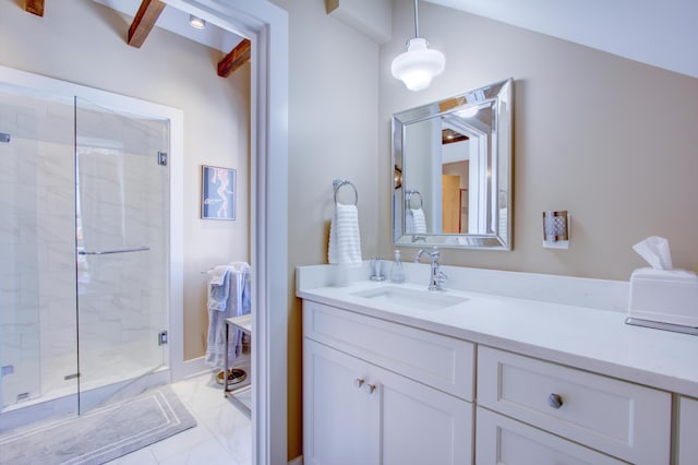 bathroom with vanity and a shower with door