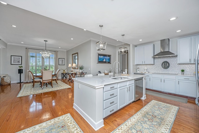 125 Pier View St Unit 408, Charleston, SC 29492 - kitchen with wall chimney range hood, stainless steel dishwasher, ornamental molding, light wood-style floors, and tasteful backsplash