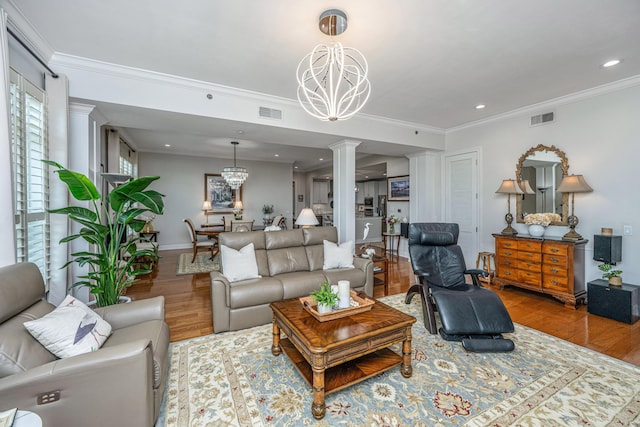 125 Pier View St Unit 408, Charleston, SC 29492 - living room featuring a chandelier, decorative columns, wood finished floors, crown molding, and recessed lighting