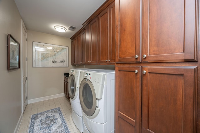 125 Pier View St Unit 408, Charleston, SC 29492 - laundry area featuring cabinet space, washing machine and dryer, and light tile patterned floors
