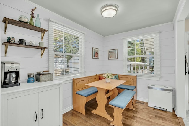 dining space with light wood-type flooring, breakfast area, and a wealth of natural light