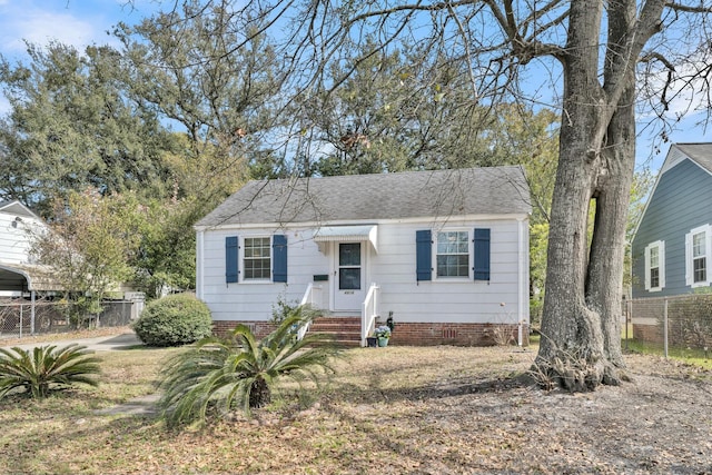 bungalow with a shingled roof, crawl space, and fence