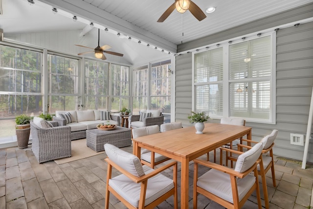 sunroom / solarium with vaulted ceiling with beams, ceiling fan, and a healthy amount of sunlight