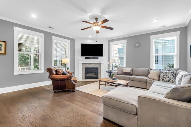 living room featuring hardwood / wood-style flooring, ornamental molding, and ceiling fan