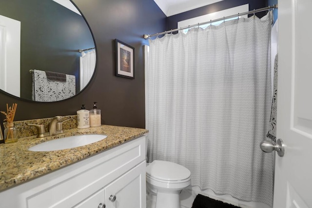 bathroom with vanity, toilet, and walk in shower