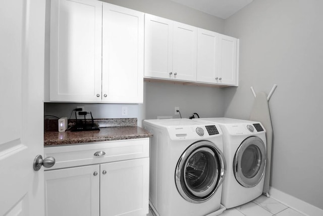 washroom featuring cabinets and washer and dryer