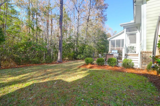 view of yard with a patio area and a sunroom