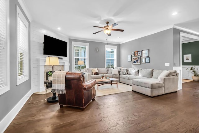 living room with ornamental molding, dark hardwood / wood-style floors, and ceiling fan