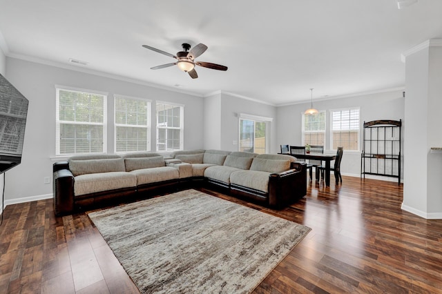 living room featuring baseboards, dark wood finished floors, and crown molding