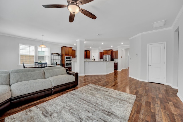 living area featuring ceiling fan, ornamental molding, dark wood-style flooring, and baseboards