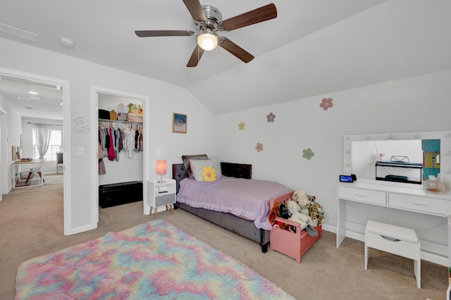 bedroom featuring light carpet, baseboards, lofted ceiling, ceiling fan, and a closet