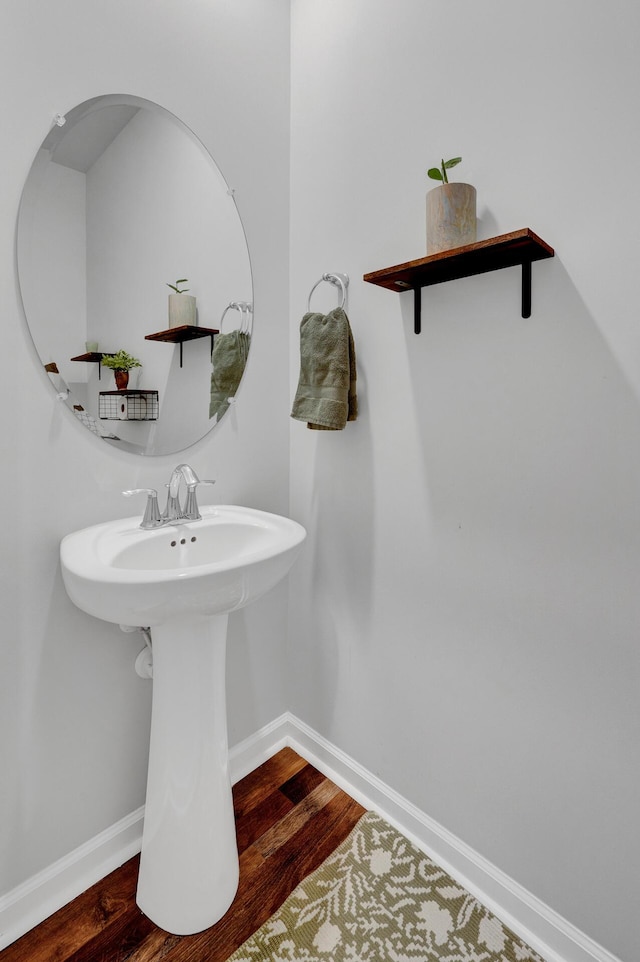 bathroom featuring wood finished floors and baseboards