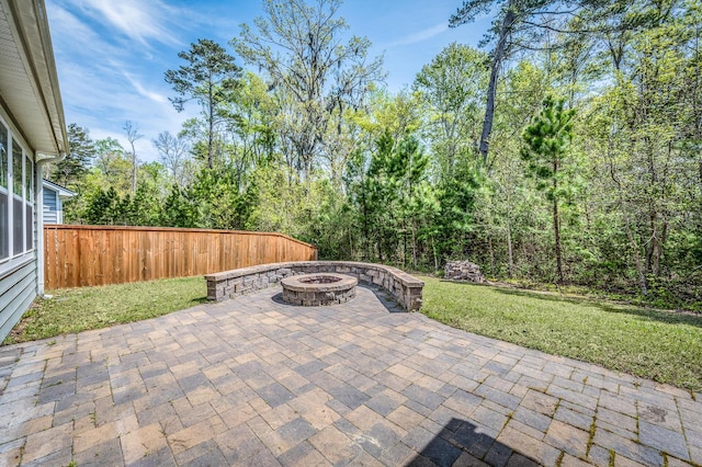 view of patio / terrace with fence and a fire pit