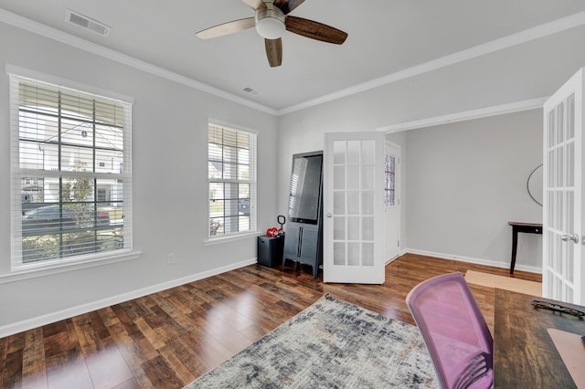 office area with crown molding, wood finished floors, visible vents, and baseboards