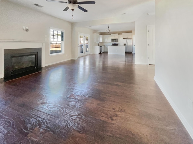 unfurnished living room featuring ceiling fan