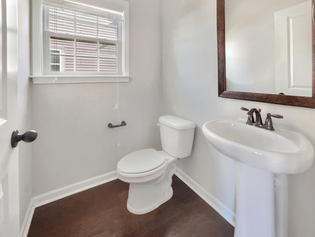 bathroom featuring sink, toilet, and hardwood / wood-style floors