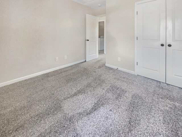 unfurnished bedroom featuring carpet floors and a closet