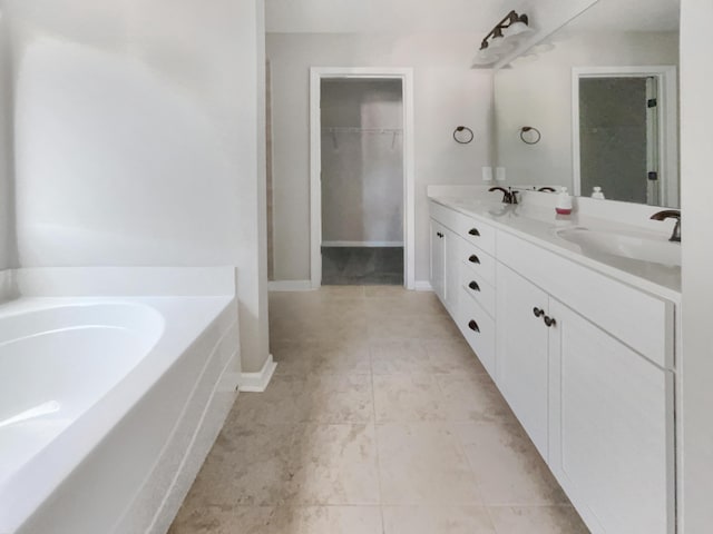 bathroom with vanity and a bath