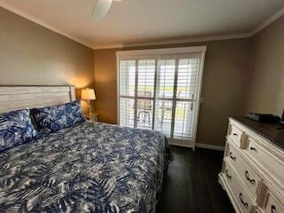 bedroom with ceiling fan, crown molding, and dark hardwood / wood-style flooring