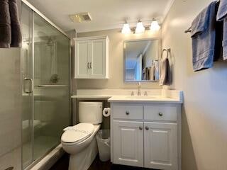 bathroom with vanity, walk in shower, and toilet