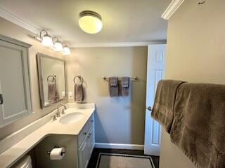 bathroom featuring ornamental molding and vanity