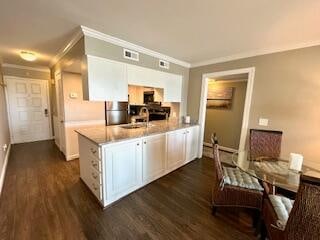 kitchen featuring crown molding, white cabinetry, sink, and dark hardwood / wood-style floors