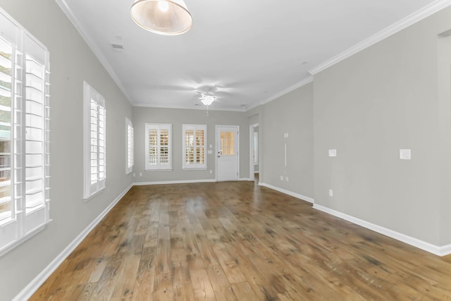 empty room featuring hardwood / wood-style floors, ceiling fan, and crown molding