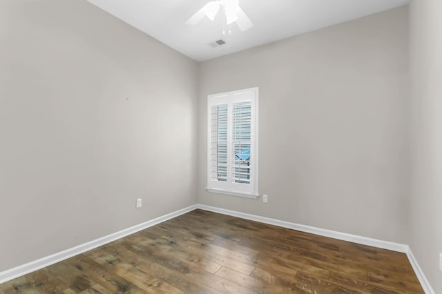 empty room with dark hardwood / wood-style floors and ceiling fan