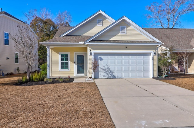 view of front of property with a garage and a front yard