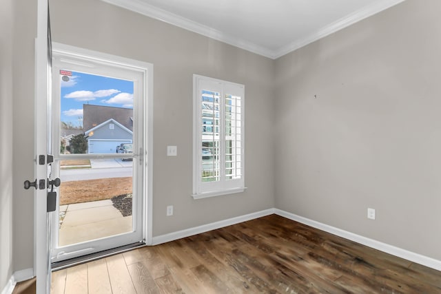 entrance foyer with hardwood / wood-style flooring and ornamental molding