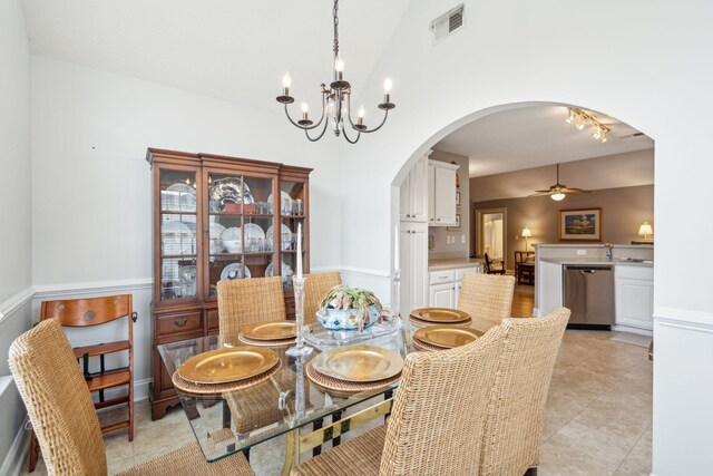 dining room with ceiling fan with notable chandelier and light tile patterned flooring