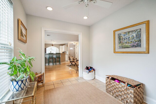 corridor with plenty of natural light and light hardwood / wood-style floors